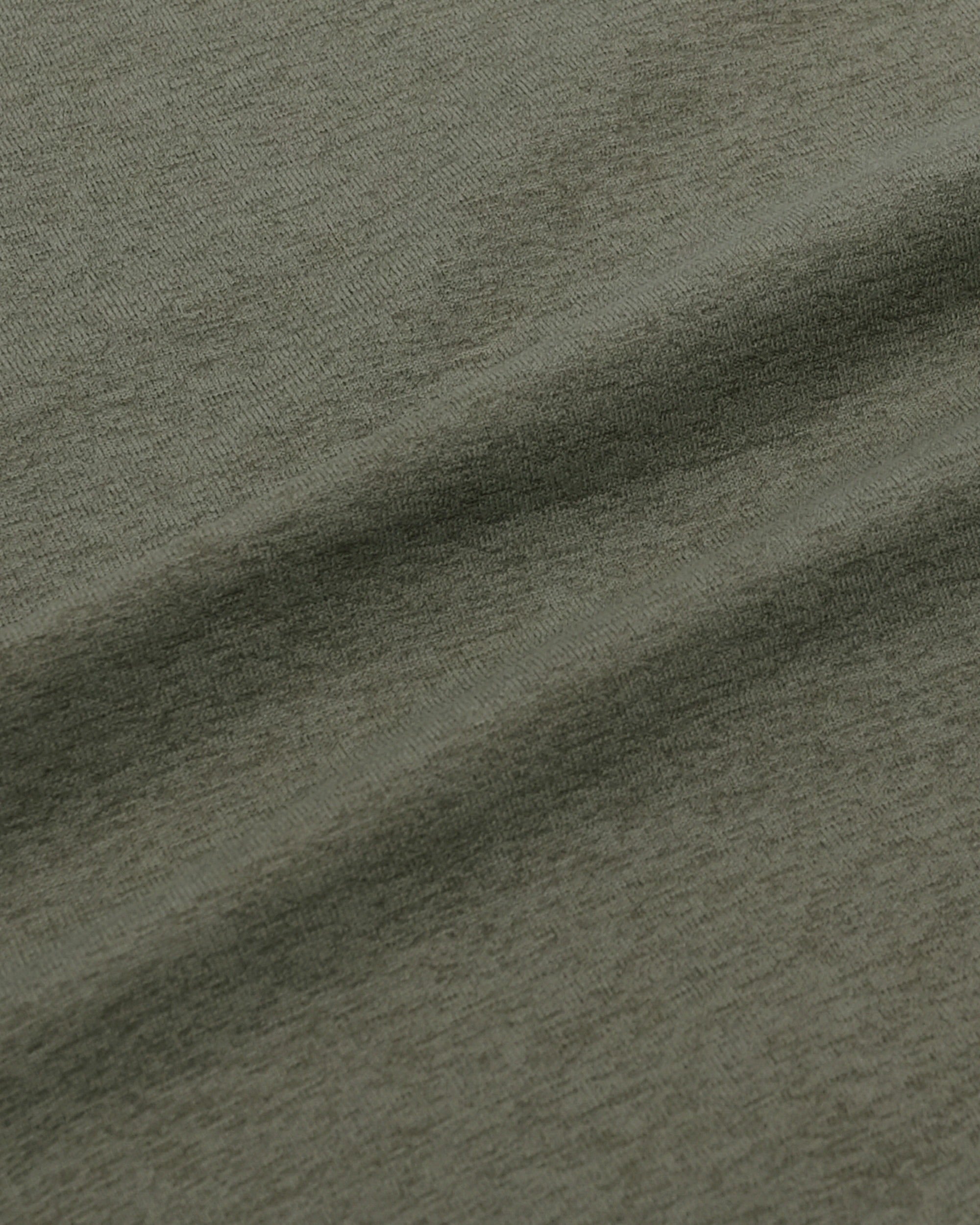 Close-up of textured green fabric with a focus on color and texture.