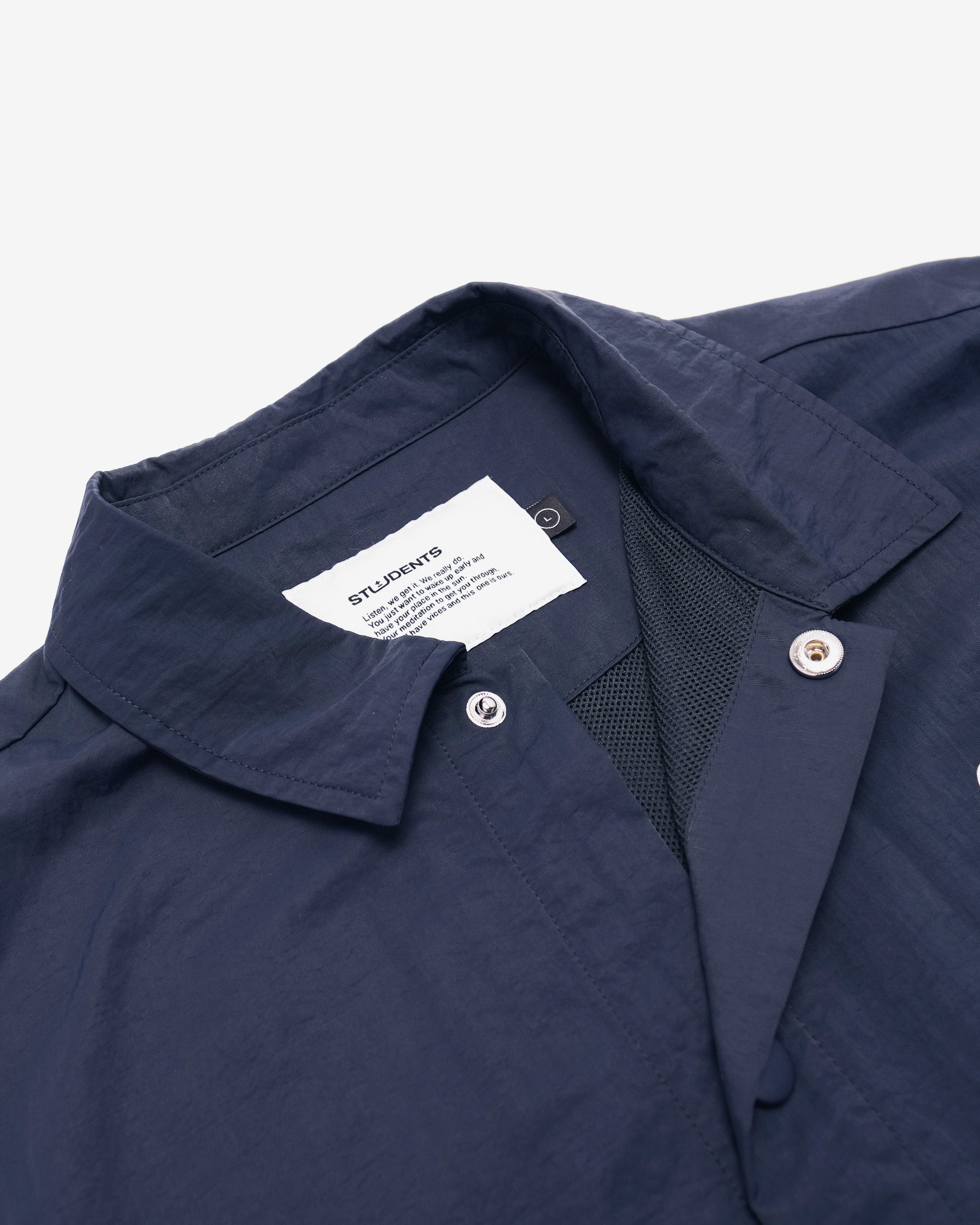 Navy blue shirt with a label on a white background