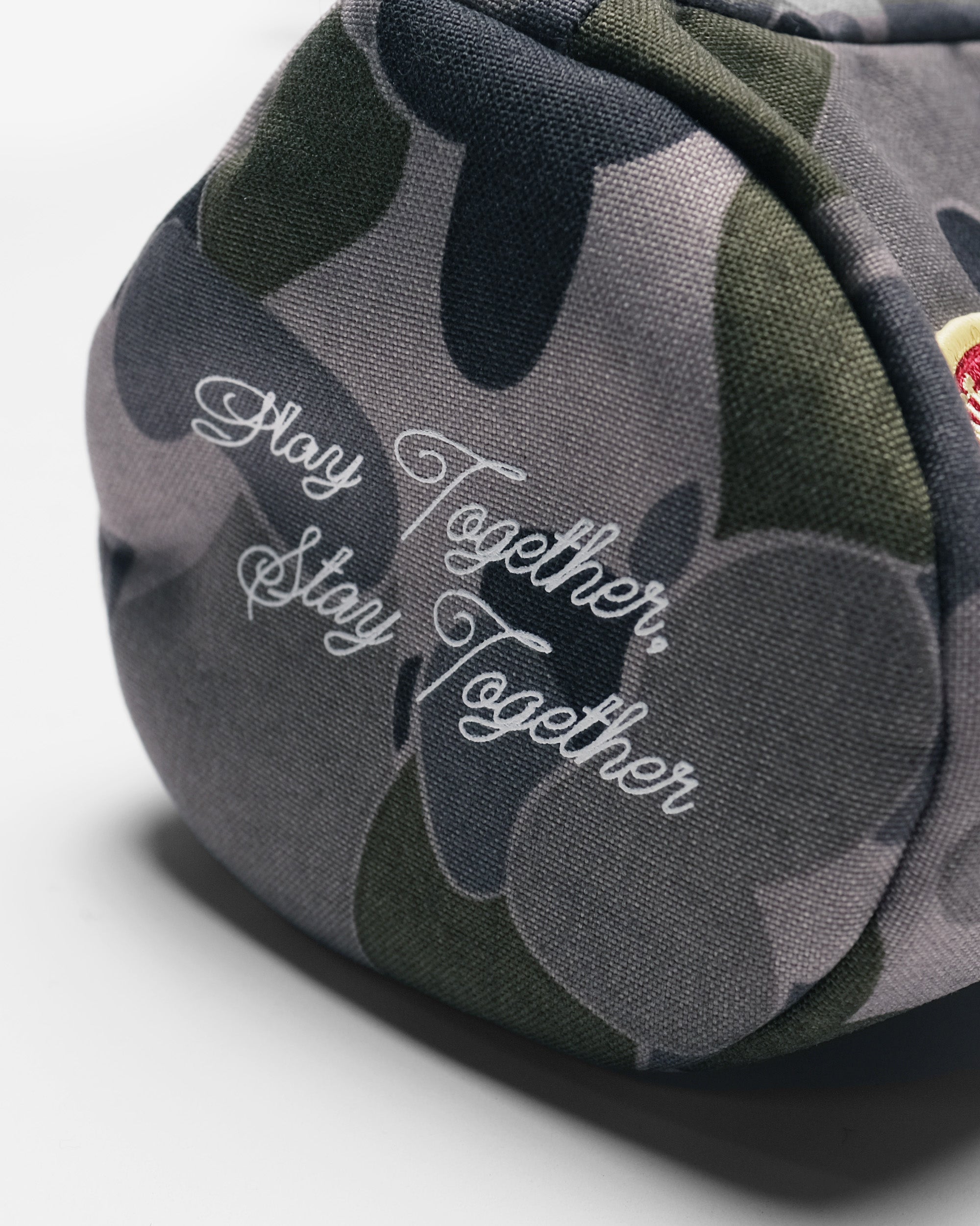 Camouflage-patterned product with 'Stay Together' text on a white background