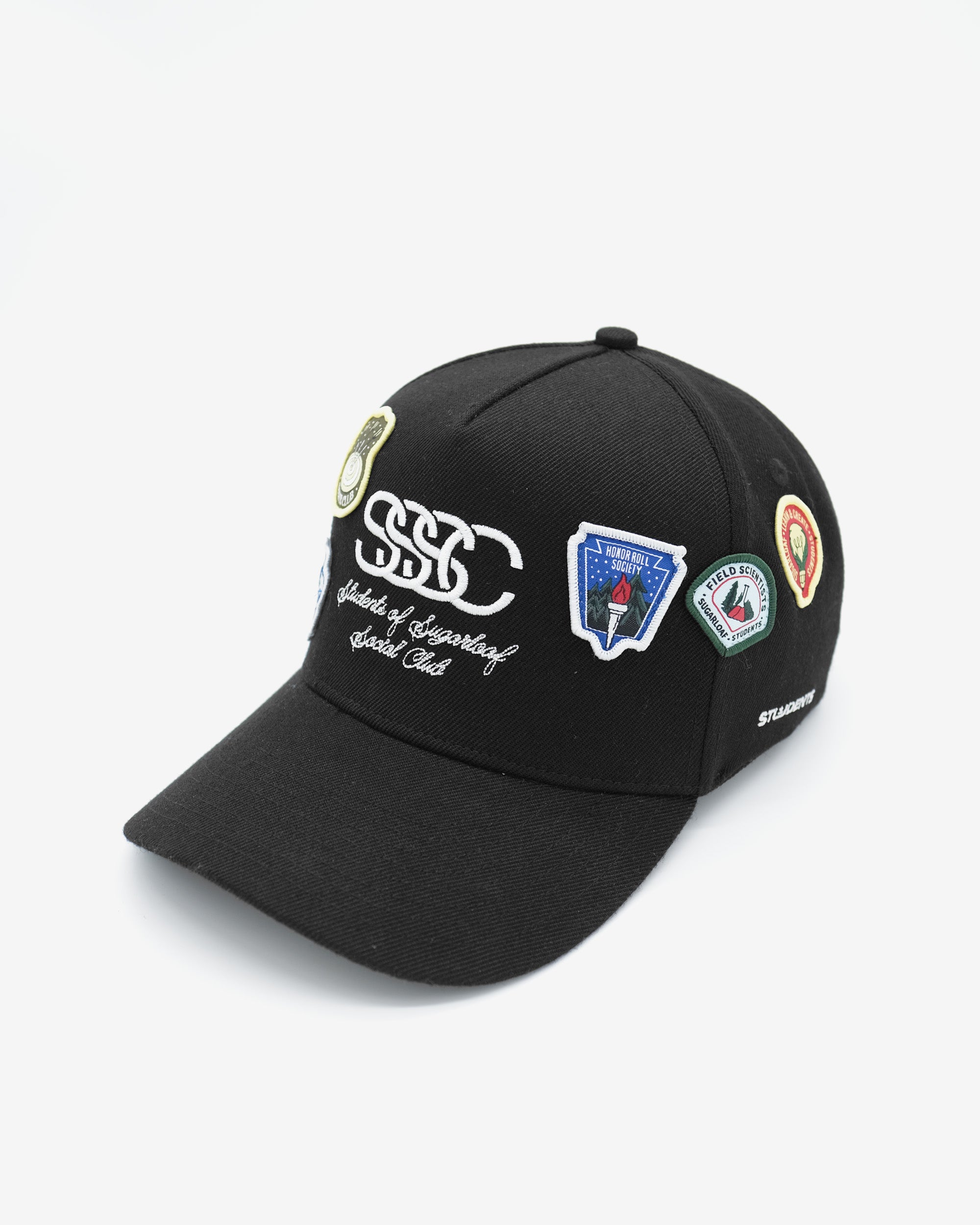 Black cap with multiple patches on a white background