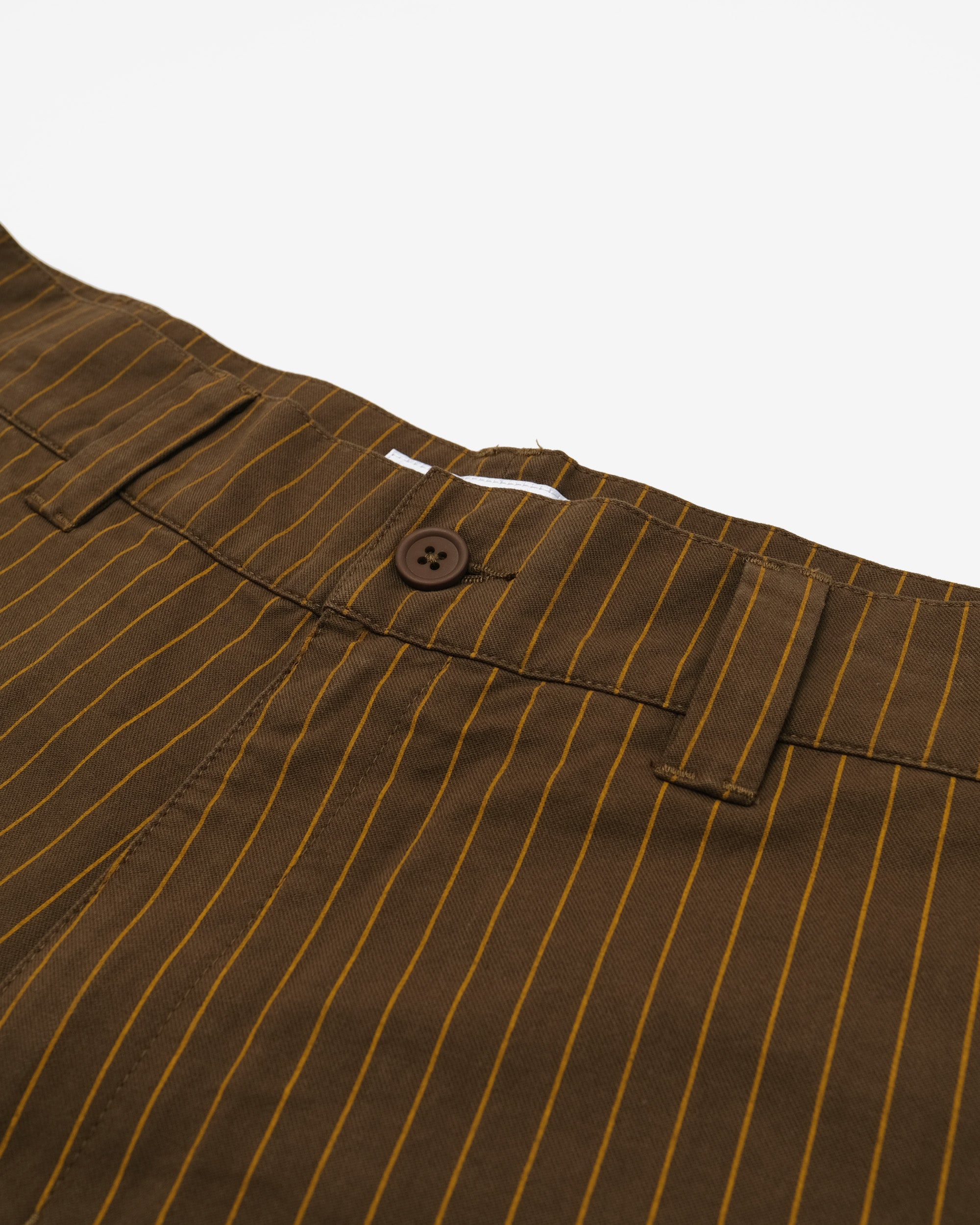 Brown pinstripe pants with a button on a white background