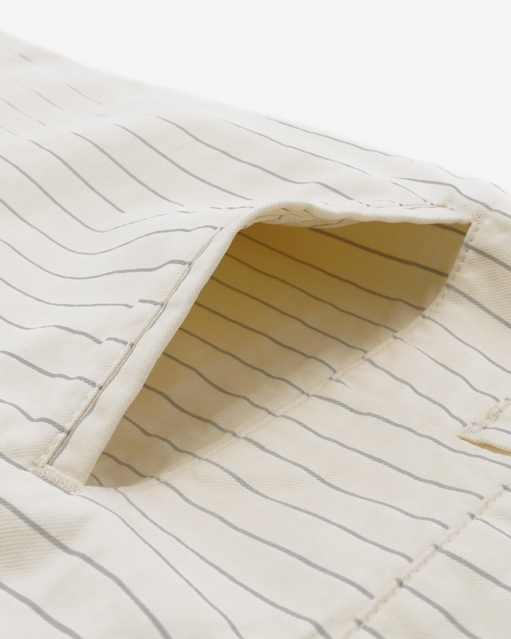 Close-up of a textured fabric with wavy lines on a white background