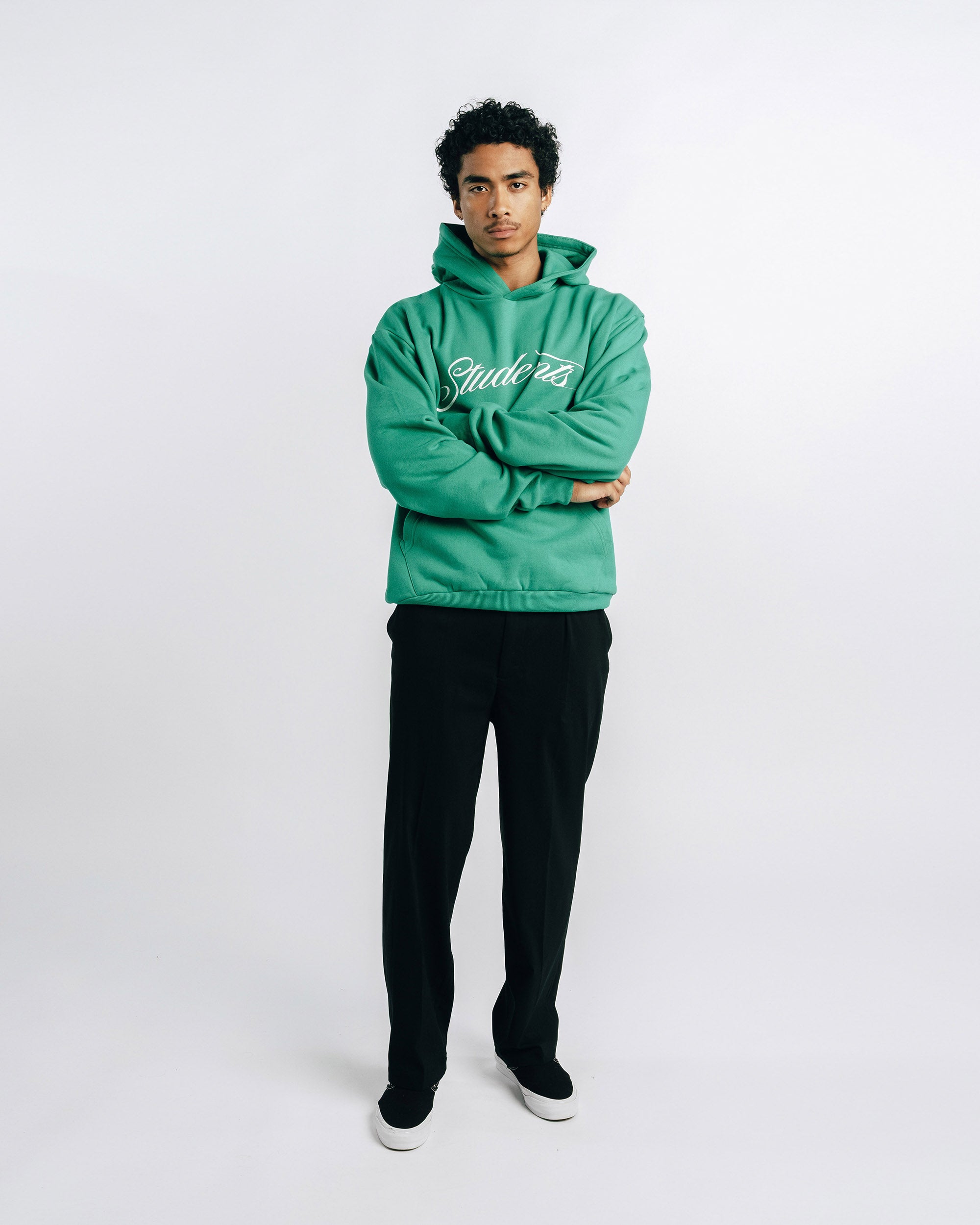 Person wearing a green hoodie with text on a white background