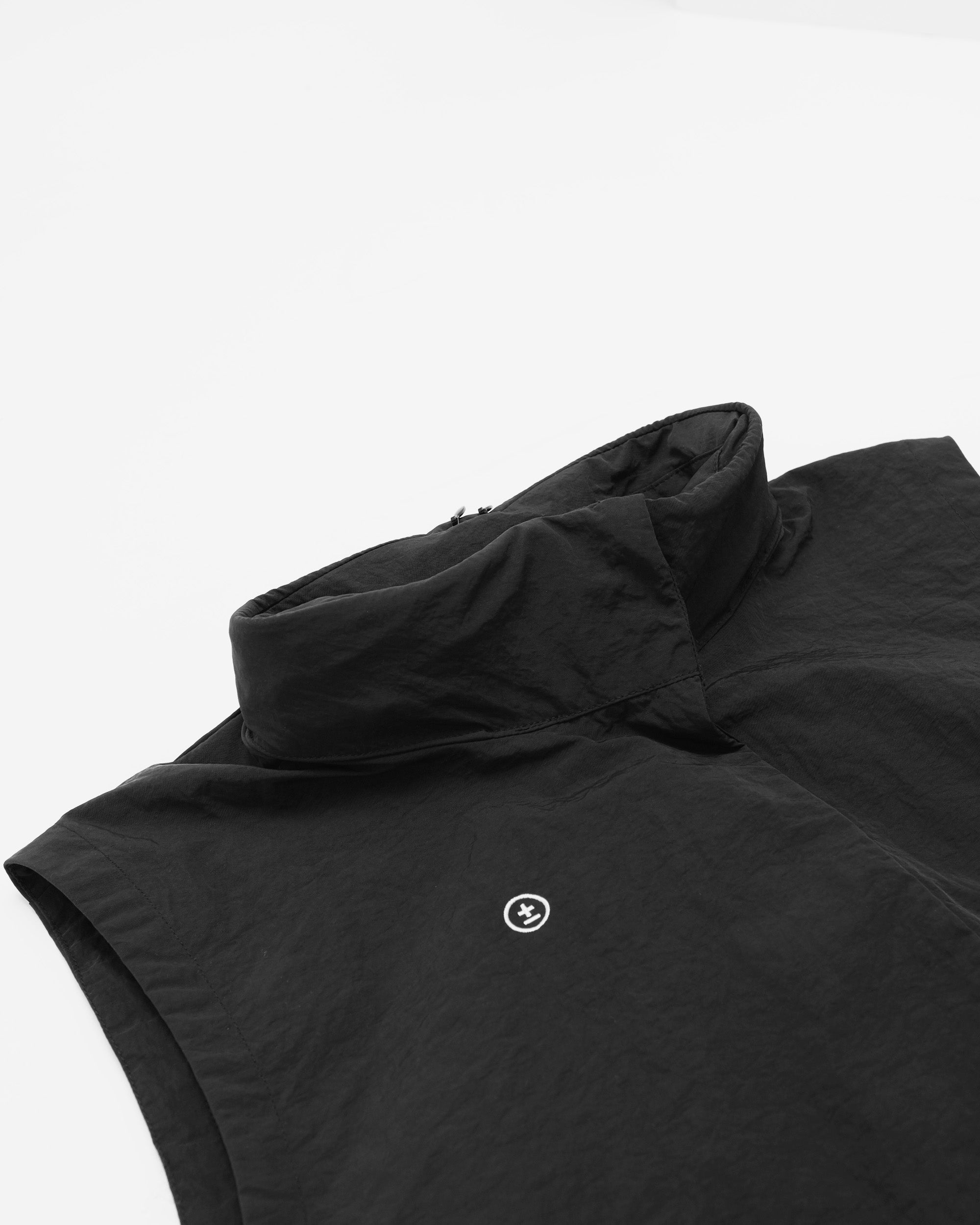 Black sleeveless jacket with a small logo on a white background