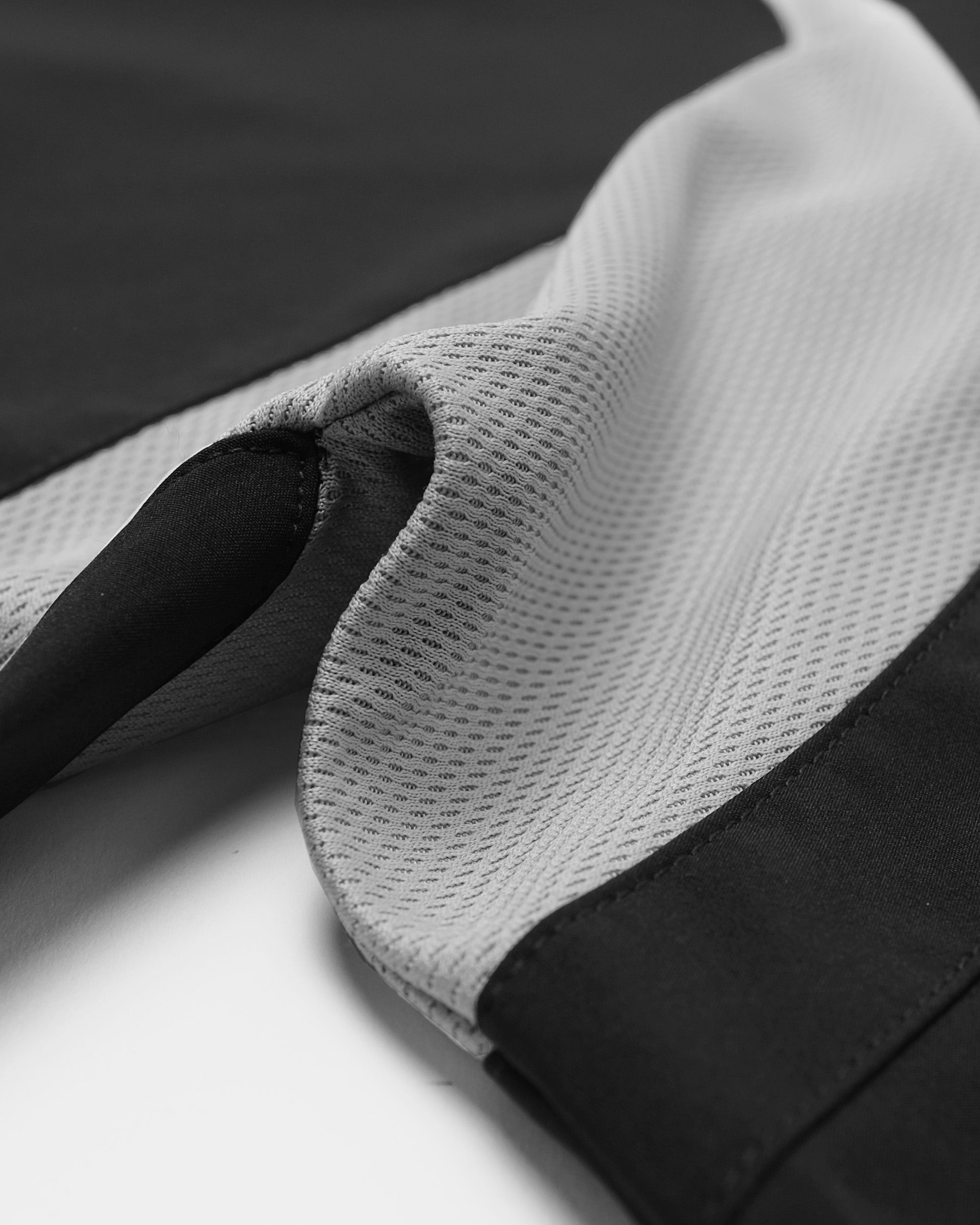 Close-up of a textured fabric with black and gray colors on a white background