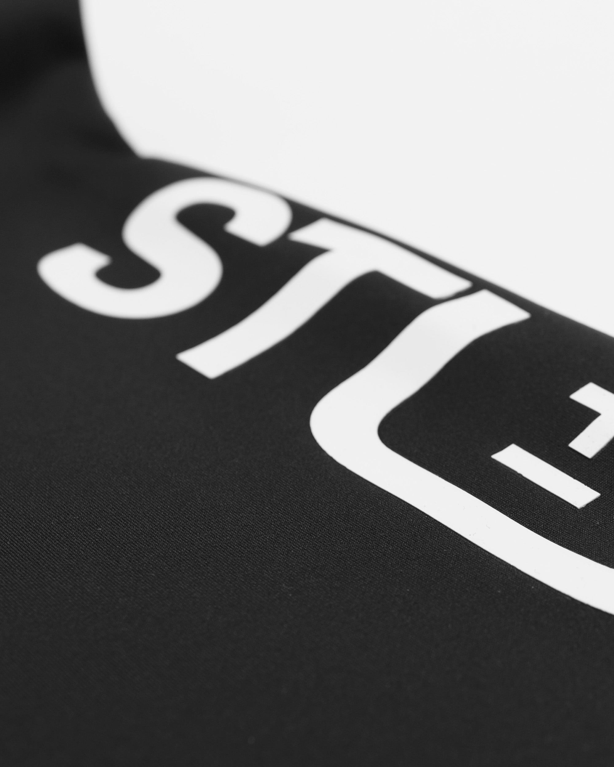 Close-up of a black shirt with white text and logo