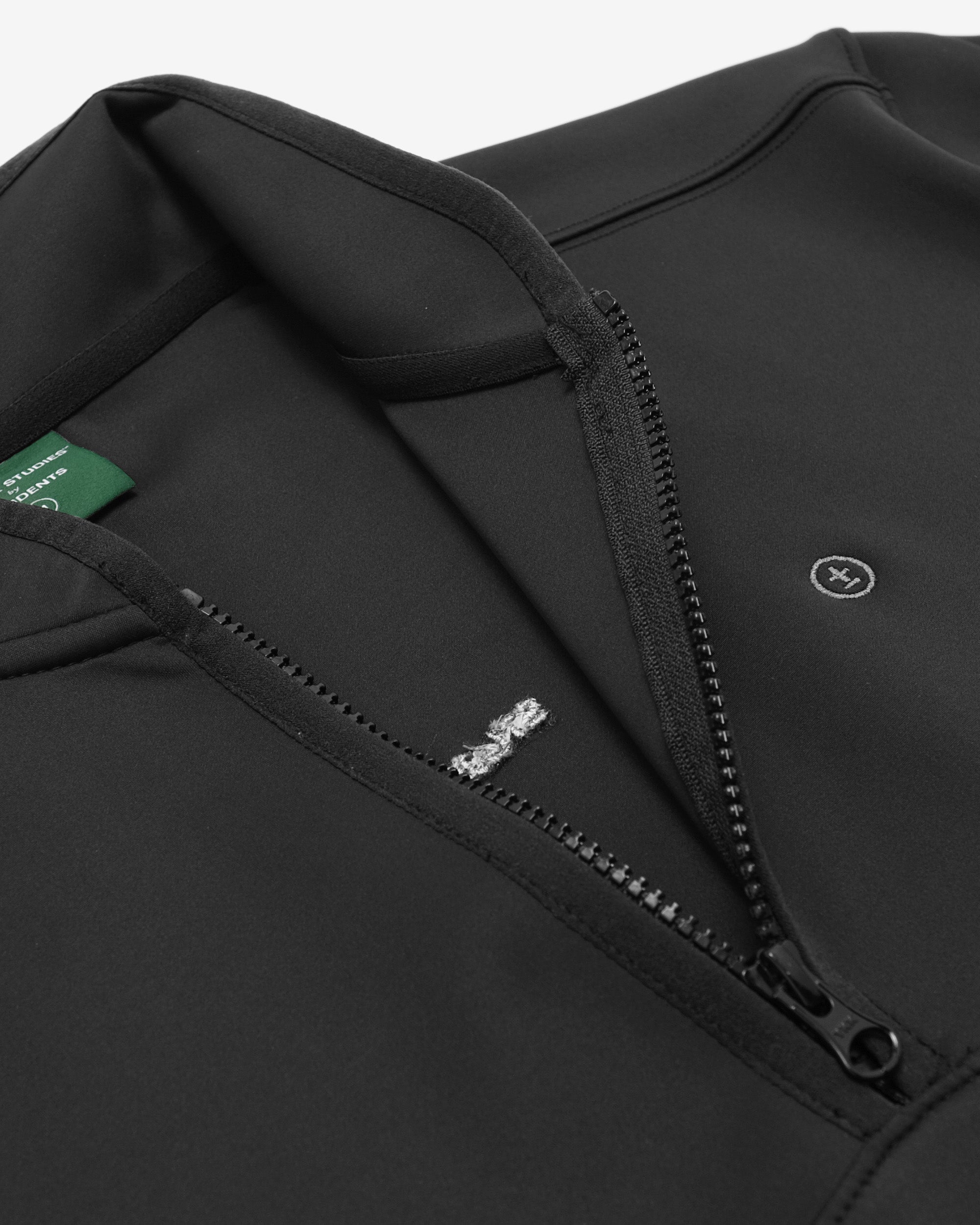 Close-up of a black jacket with a zipper, featuring brand logos.
