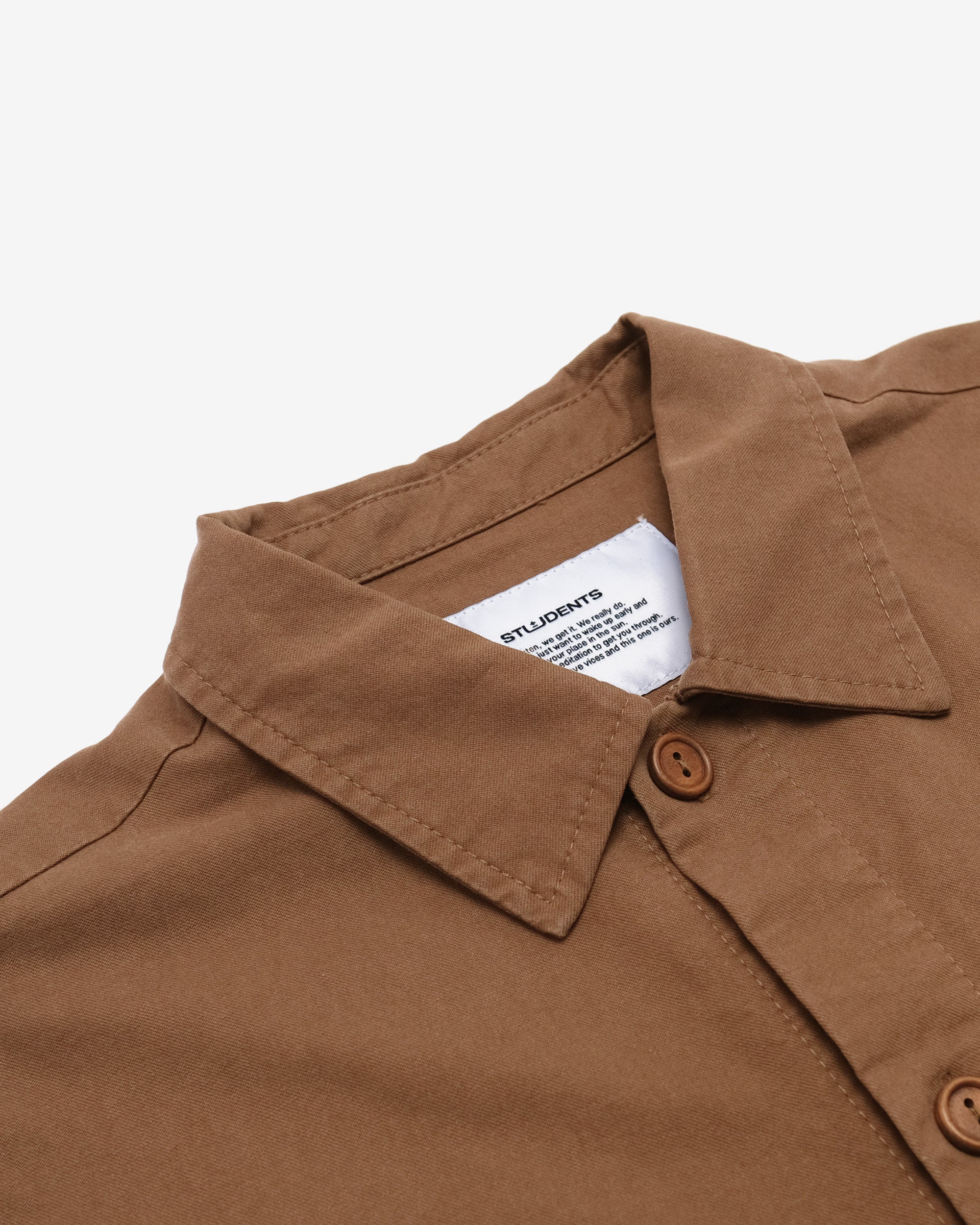 Brown shirt collar with a brand label on a white background