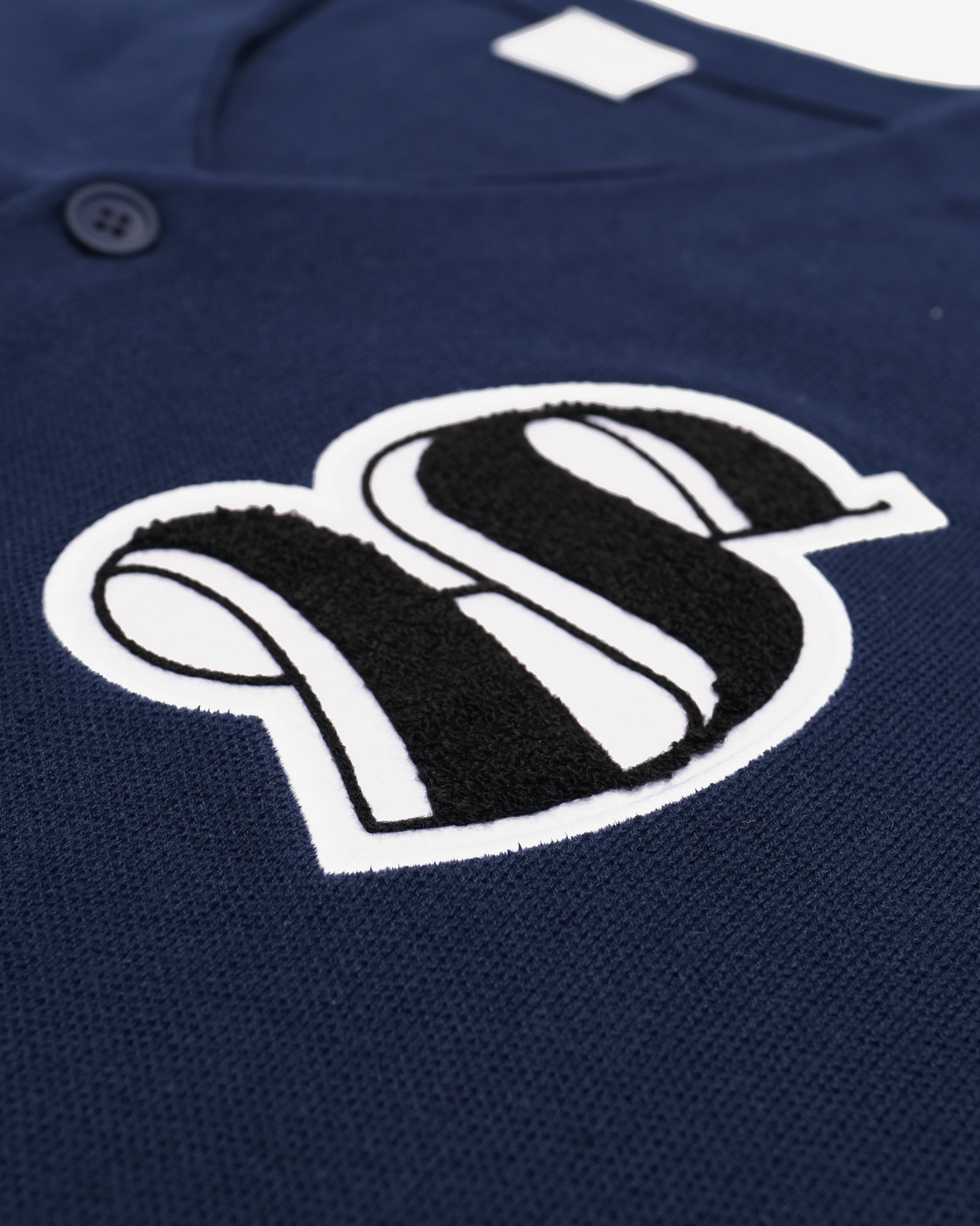 Navy blue shirt with a white logo on a white background