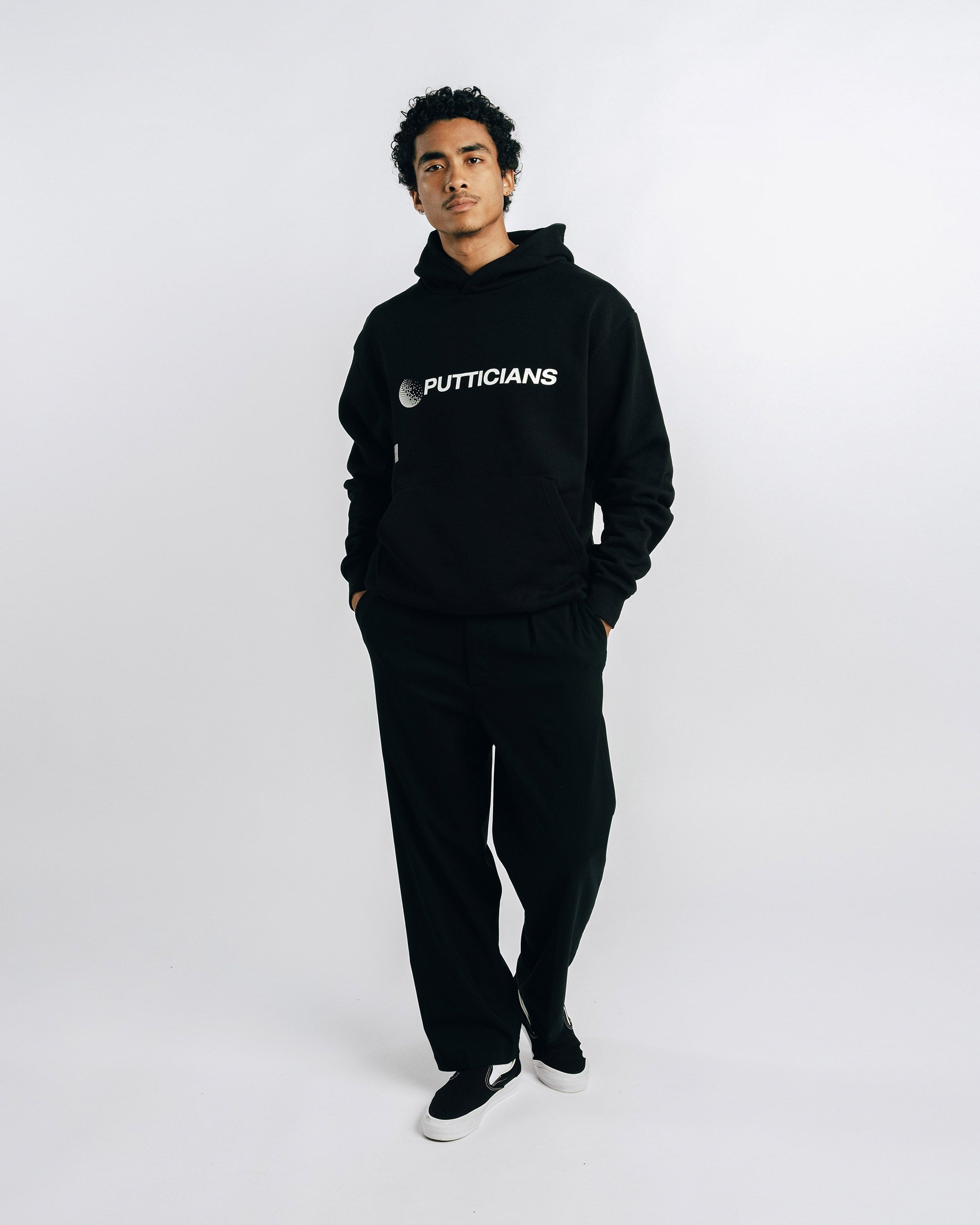 Person wearing a black hoodie with text on a white background